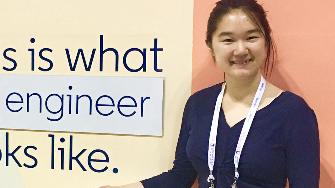 Elizabeth poses with a sign that says, "This is what an engineer looks like."