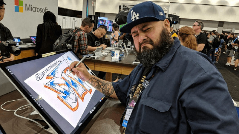 Dan drawing on large tablet in a Microsoft store.