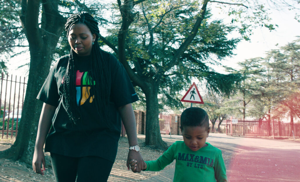 Vuyo and her son walking together outside.