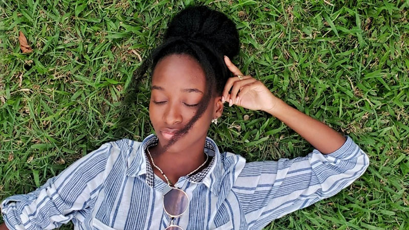 Juleen laying and relaxing in the grass.